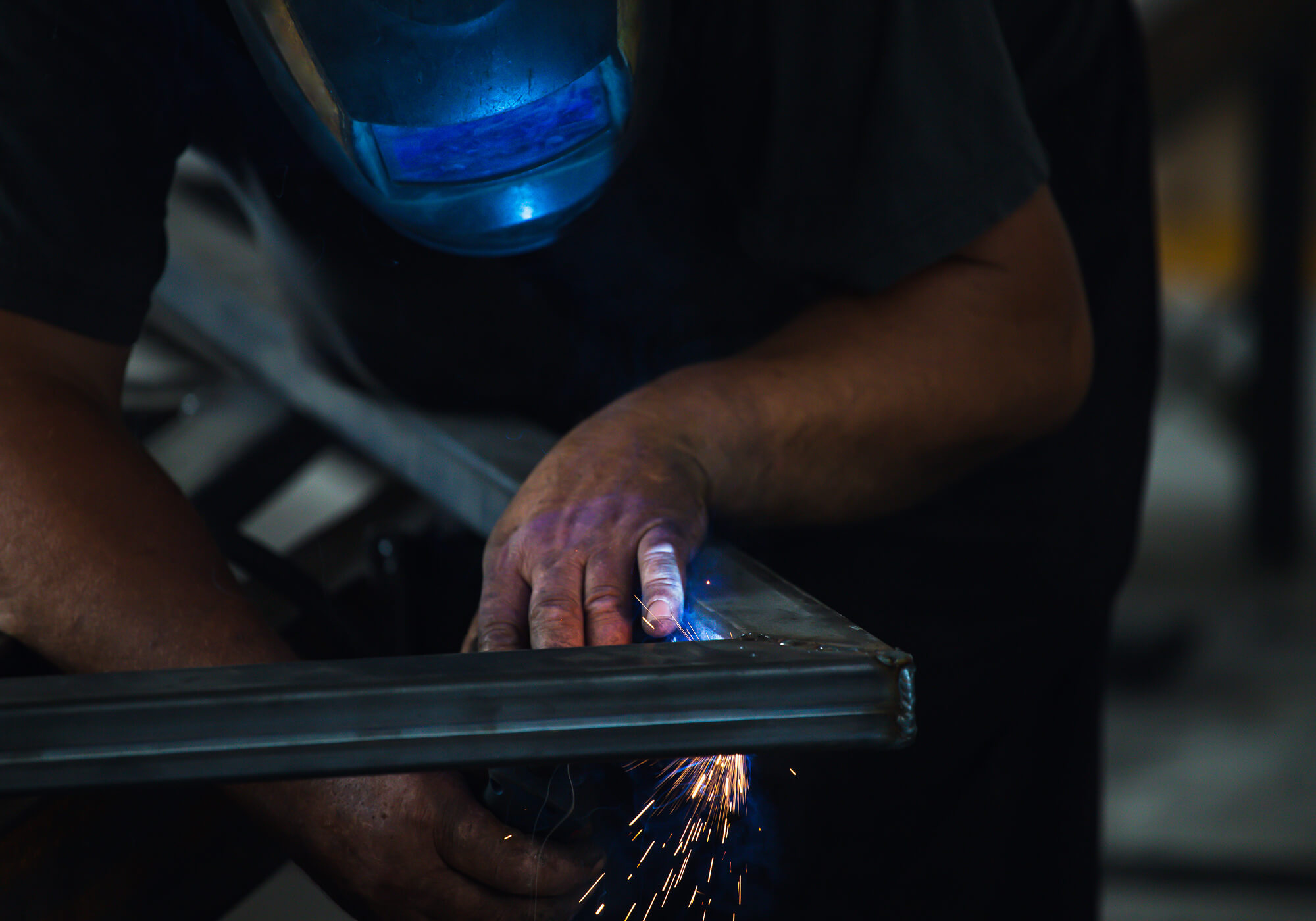 industry-worker-welding-iron-pieces-at-work-TN68MSH.jpg