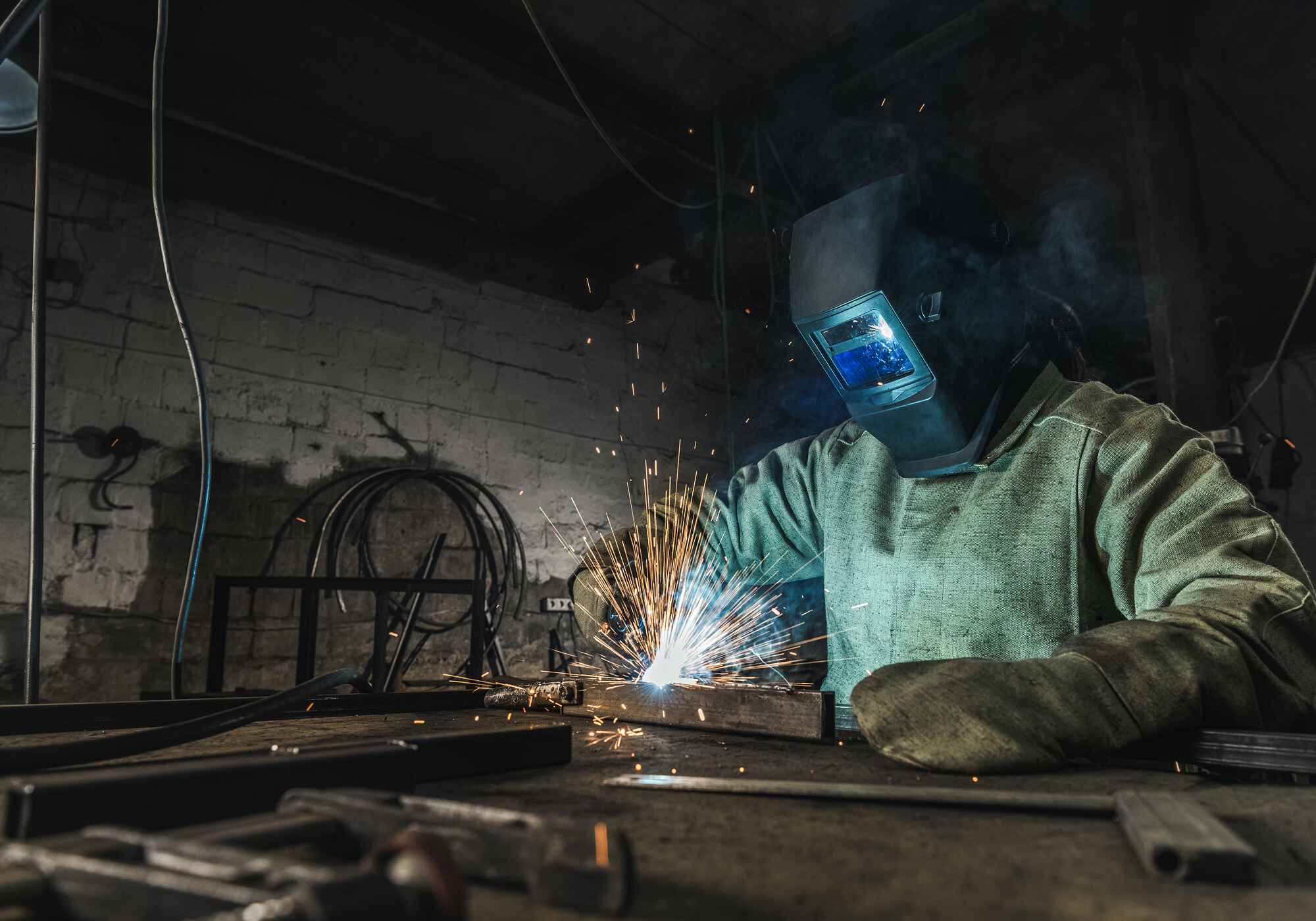 manual-worker-in-protective-helmet-with-welding-to-ZLA79LH.jpg